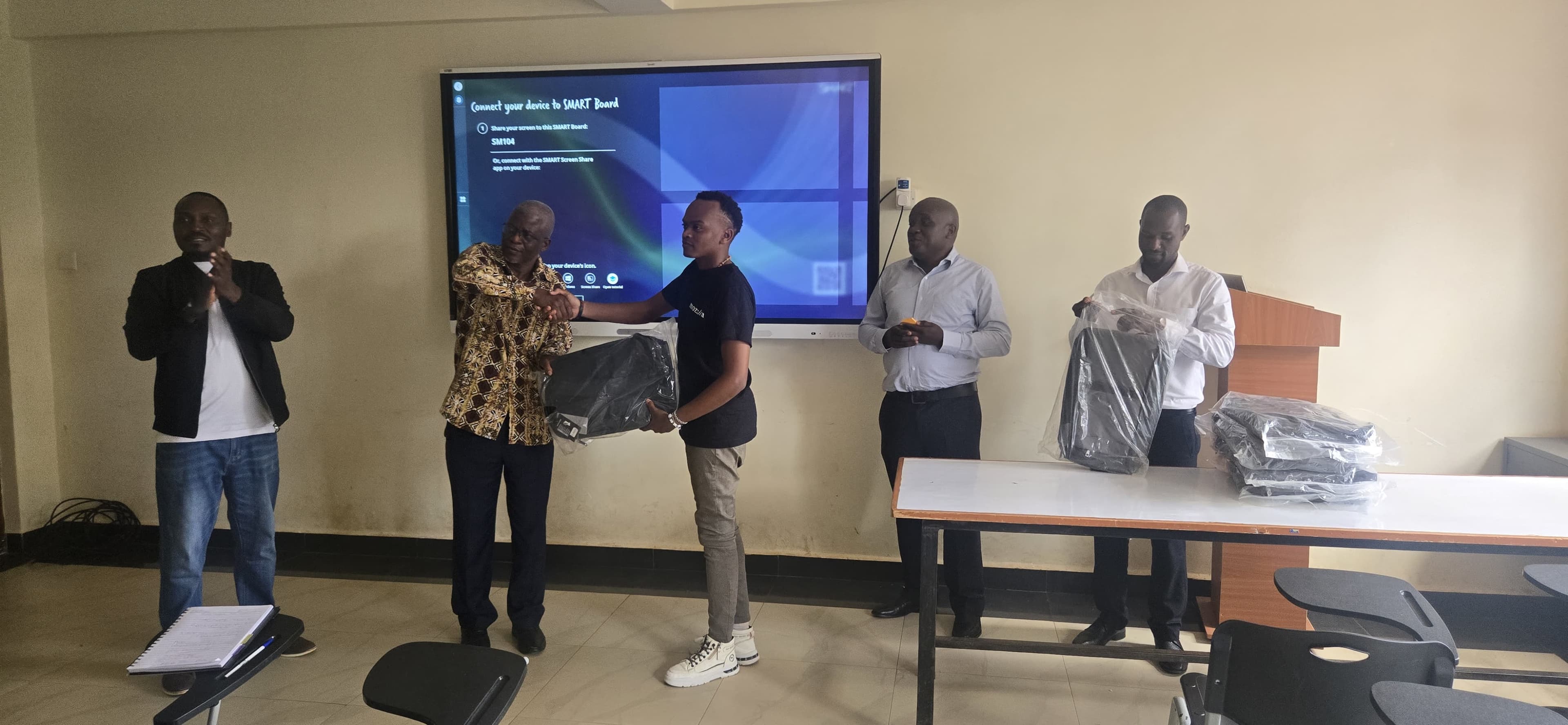 Animator Bill Gitonga being recognized with a gift for their creative work on the project.