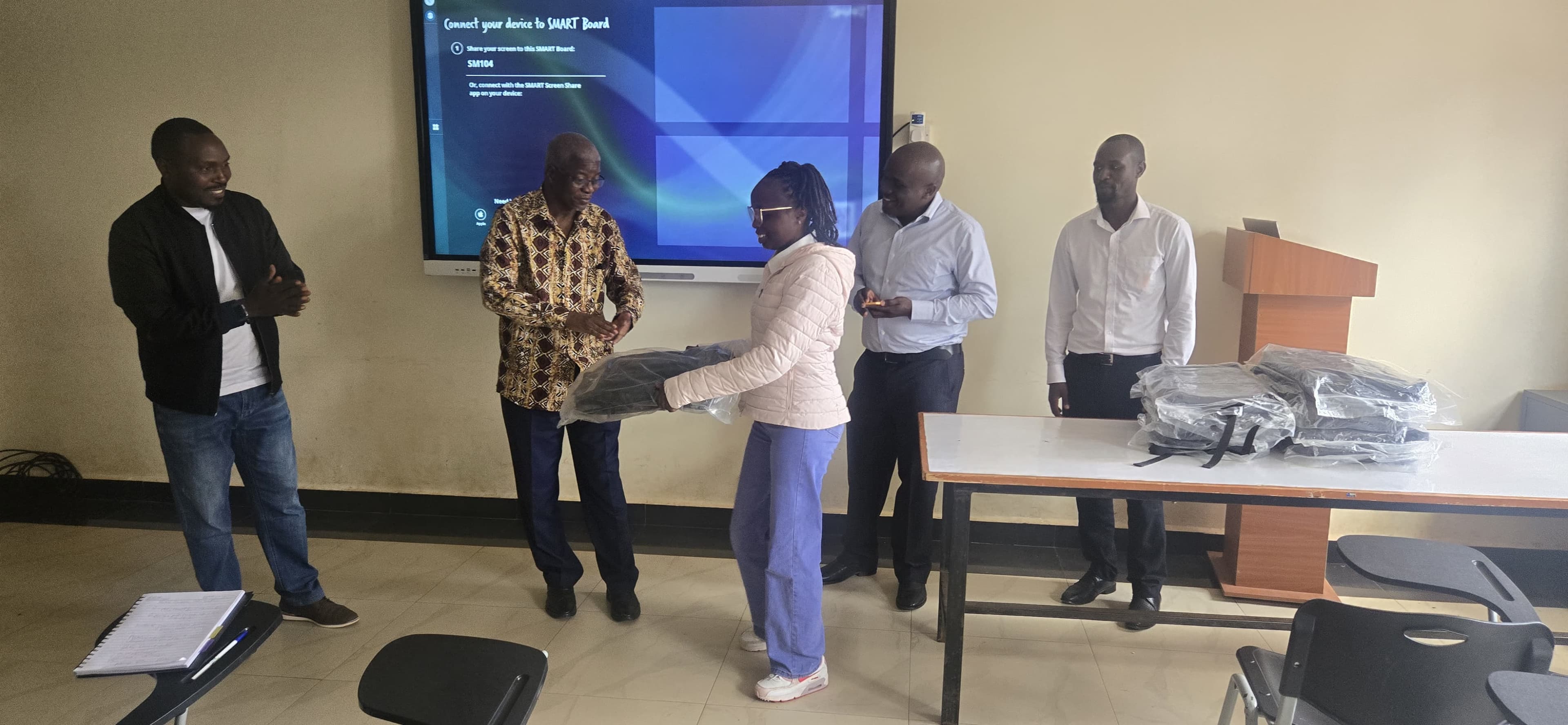 Animator Joy Njuguna presented with a token of appreciation for their dedication to the animation initiative.