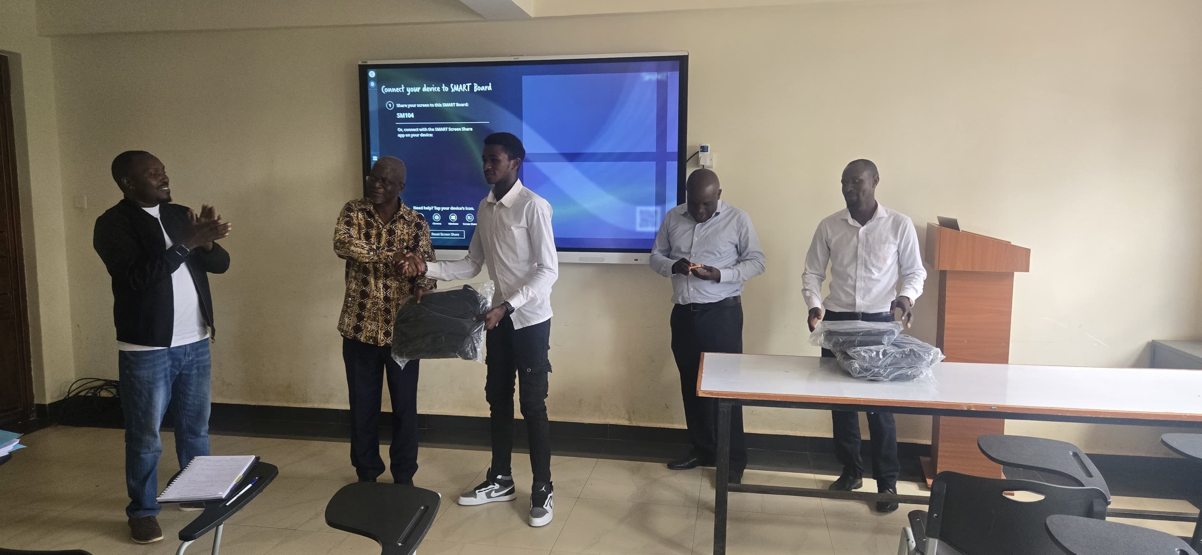 Animator Patric Wambugu being honored with a gift for their work in promoting responsible computing through animation.