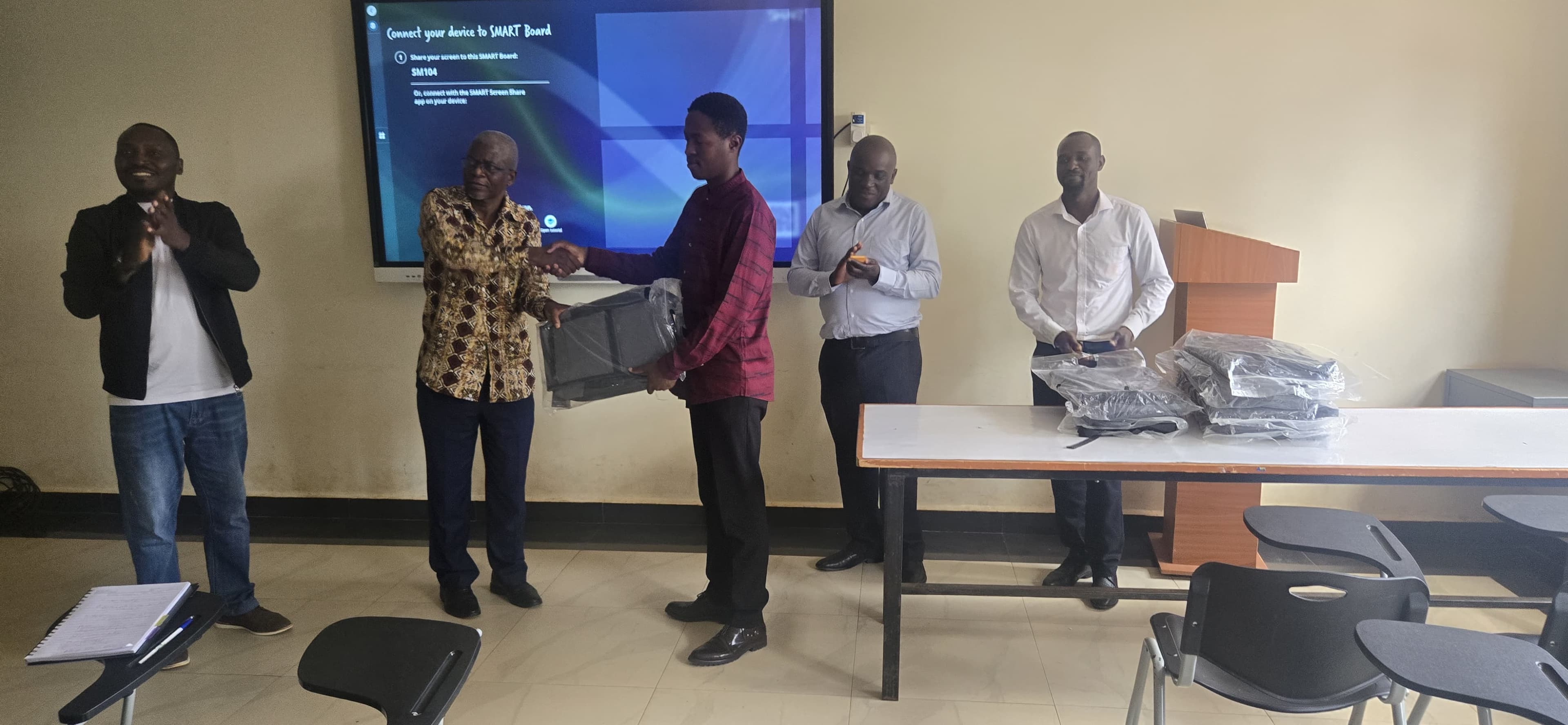 Animator Victor Mworia receiving a token of appreciation for their efforts on the project.